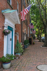 Beautiful picturesque New England style house facades in historic Old Town Alexandria, Virginia with shopping avenue mall King Street and romantic backstreet alley brick buildings colors Indian Summe