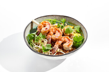 Chinese traditional dish - fried rice with egg, vegetables, and prawn. Pan asian wok with rice and shrimp on white background. Nasi goreng with prawns on isolated background with shadows.