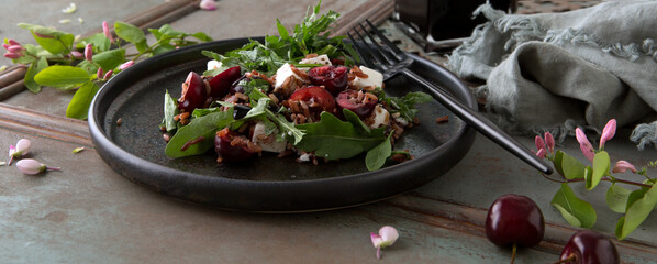  plate of salad with rice, arugula, feta and cherry on wooden table