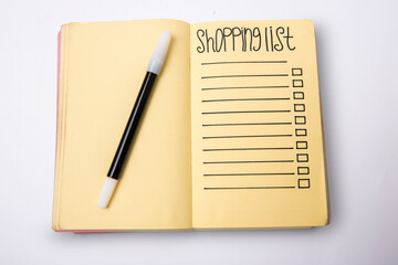 Empty shopping list text on a note pad with black marker