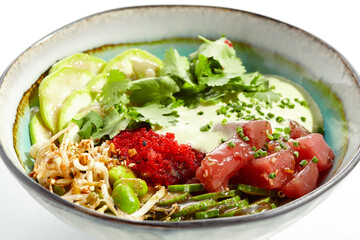 Healthy food - poke bowl with tuna, rice, fresh vegetables and Hawaiian sauce. Hawaiian meal poke bowl with tuna isolated on white background. Dinner for slimming.