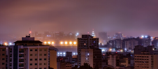 Fototapeta premium Niterói, Rio de Janeiro, Brazil - CIRCA 2021: Long exposure urban night photography with buildings and lights of a Brazilian city
