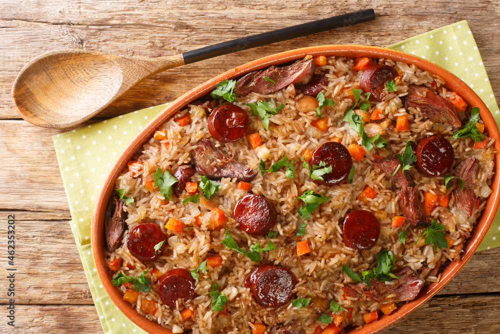 Wall mural portuguese duck rice arroz de pato cooked with red wine, onion, carrot and chorizo close up in the b - Wall murals