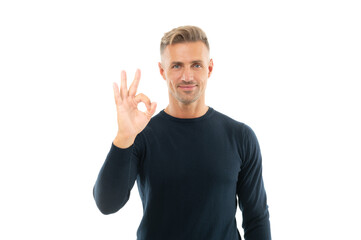 Happy caucasian handsome guy in black sweatshirt show okay ring gesture isolated on white, OK