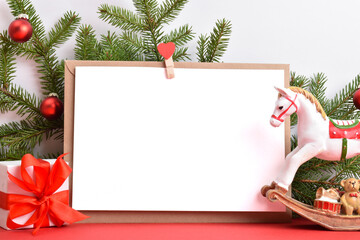 Christmas background from an envelope with gifts and a fir branch and a horse on a red background. Happy New Year 2022. copy space