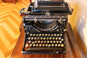 An old vintage Typewriter with spanish keyboard over a wooden desk.