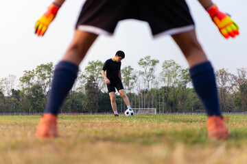 Sports and recreation concept a male amateur player practicing as a goalkeeper position rehearsing to catch the ball from free-kicks