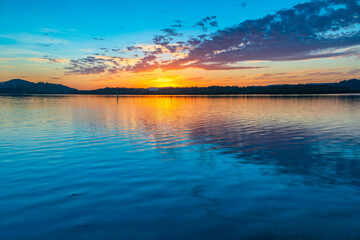 Fototapeta premium Sunrise waterscape and clouds with reflections