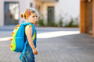 Cute little adorable toddler girl on her first day going to playschool. Healthy upset sad baby...