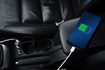 Mobile phone ,smartphone, cellphone is charged ,charge battery with usb charger in the inside of...