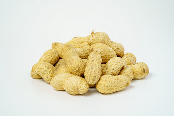 Pile of dried peanuts isolated on white background. Closeup of unpeel peanuts. 