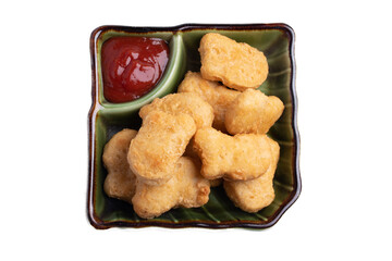 Chicken nuggets with tomato sauce in green plate