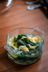 wakame seaweed soup with egg on wooden background