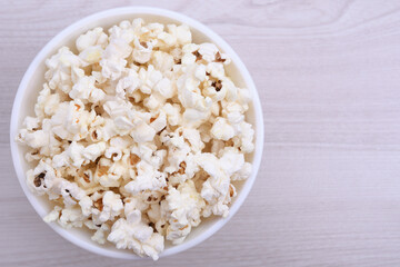 Popcorn in bowl on a red background. Close up. Top view