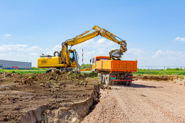 Excavator is digging on building site