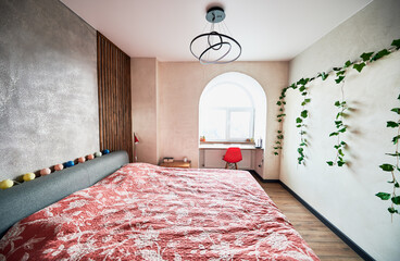 Bright bedroom with modern furniture and trendy lamps and good light from window. Concept of bright...