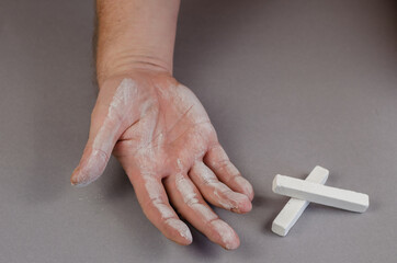 Pieces of chalk. Man's hand stained with white chalk. Right open