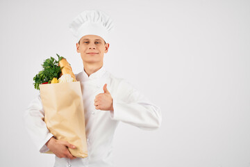 male chef with a package of groceries restaurant cooking professional