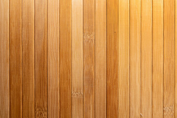 Background made of vertical yellow bamboo laths.texture, background of brown bamboo.