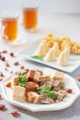 Oriental sweetness.  Nougat, halva and  tea on a table.