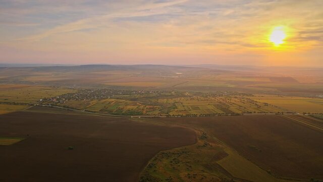 Aerial drone view of nature in Moldova at sunset. Village, fields and hills