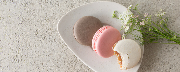 a saucer with macaroons on a light table