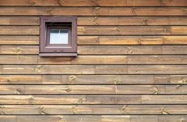 Window on the wooden wall of the house.