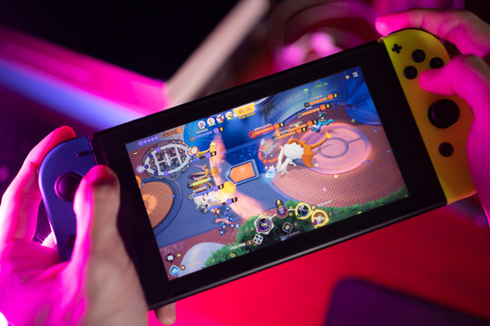 Bangkok, Thailand - October 12, 2021 : A gamer playing Pok&eacute;mon Unite on Nintendo Switch.