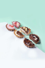 Half-cut raw vegan cupcakes on a split white and tiffany blue background. Side view.