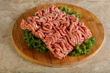 Raw pork minced meat over board