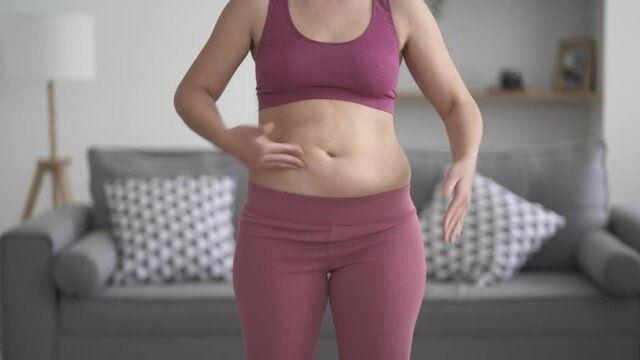 Abdominal massage, tummy tuck and flabby skin on a fat belly, woman doing self-massage, plastic surgery concept