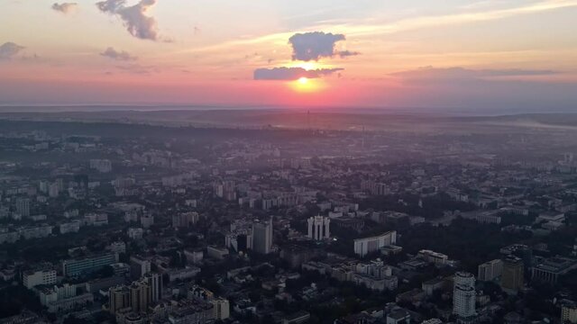 Aerial drone view of Chisinau at sunset. Panorama view of multiple buildings, roads. Moldova