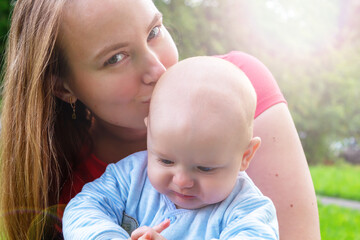 Happy smiling mother with son. Summer walk.