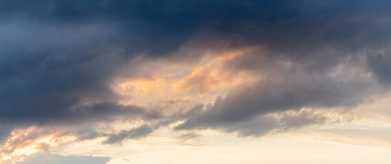 Naklejka na ściany i meble Dramatic sky with dark clouds at sunset