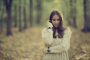 Plakat sad girl in autumn park, stress loneliness young person female