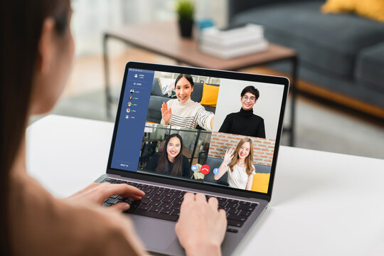 woman using laptop on table with making video call meeting to team online and present work projects. Concept working from home.