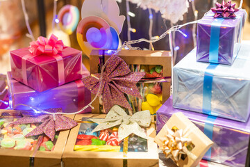 Outdoor Christmas holiday presents decorations gift boxes tied to tree on town street winter idea concept fun