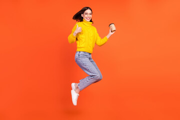 Fototapeta na wymiar Full size profile side photo of young woman happy positive smile show fine ad sign jump coffee isolated over orange color background