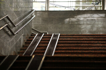 Pedestrian crossing staircase. Two handrails for wheelchairs. Metal railings for bicycles, wheelchairs and strollers with children. Special equipment on the stairs.