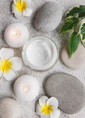 Fototapeta na wymiar Spa treatment with massage stones and moisturizing cream