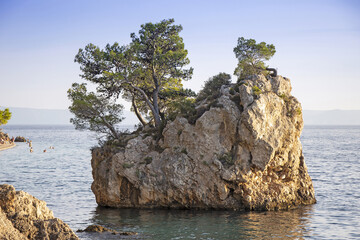 Small stone islet on Punta Rata beach in Brela