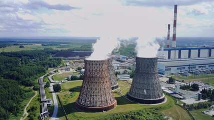 Nuclear power plant, large pipes from which steam, clouds