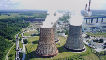 Nuclear power plant, large pipes from which steam, clouds