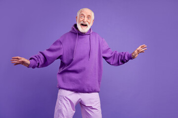 Portrait of attractive cheerful man good mood having fun isolated over bright violet purple color background