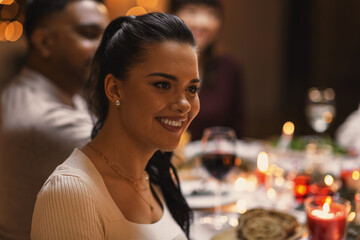 holidays, party and celebration concept - happy woman having christmas dinner with friends at home