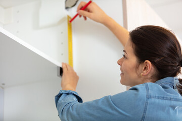 woman using leveling tool at home
