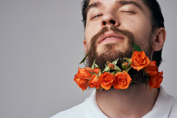 portrait of a man posing flowers in a beard fashion close-up