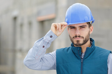 handsome bearded builder with protective helmet