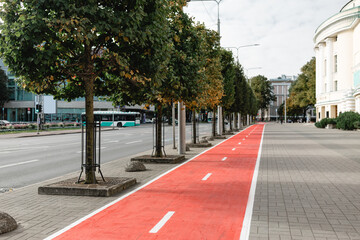 traffic, road marking and city concept - bike lane or red road for bicycles on street in tallinn,...
