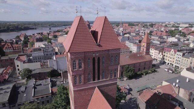 Torun, a Polish city during the day. A sunny and slightly cloudy day in Toruń on the Vistula River.